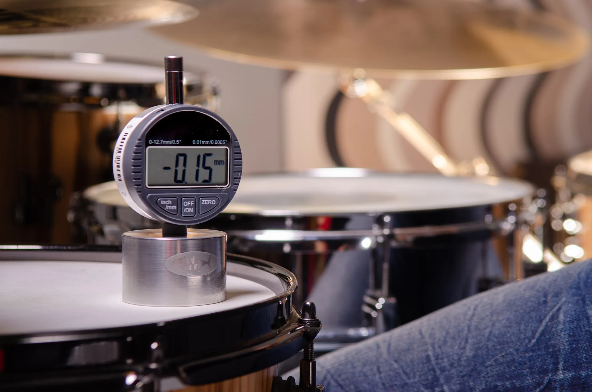 Close-up of a digital tuning gauge measuring drum head tension, music equipment brand photography by Hector's Eye